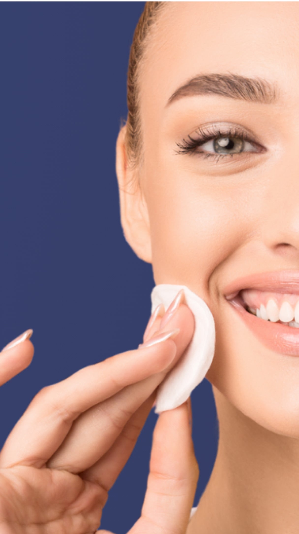 Woman cleaning her face with a cotton pad against a blue background