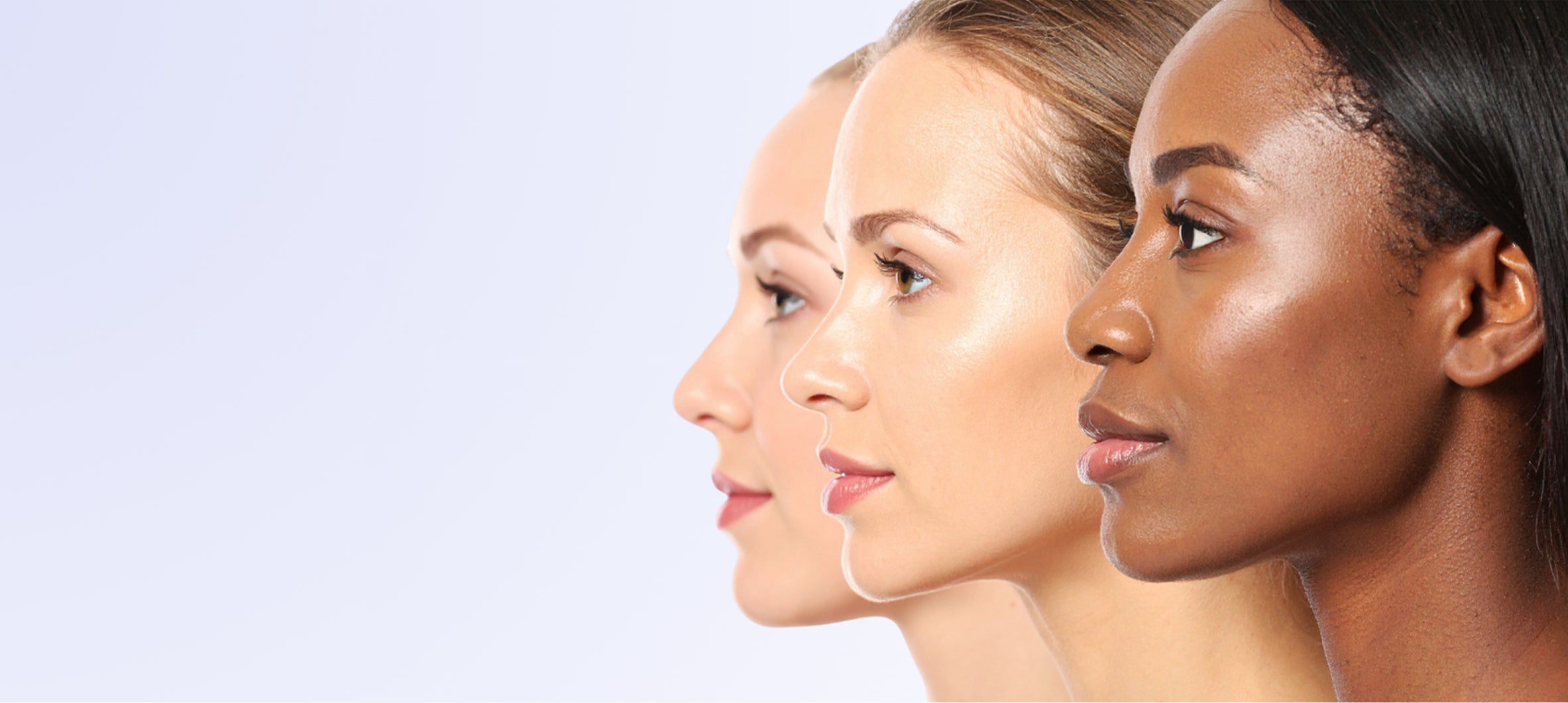 Three women with different skin tones on a light purple background